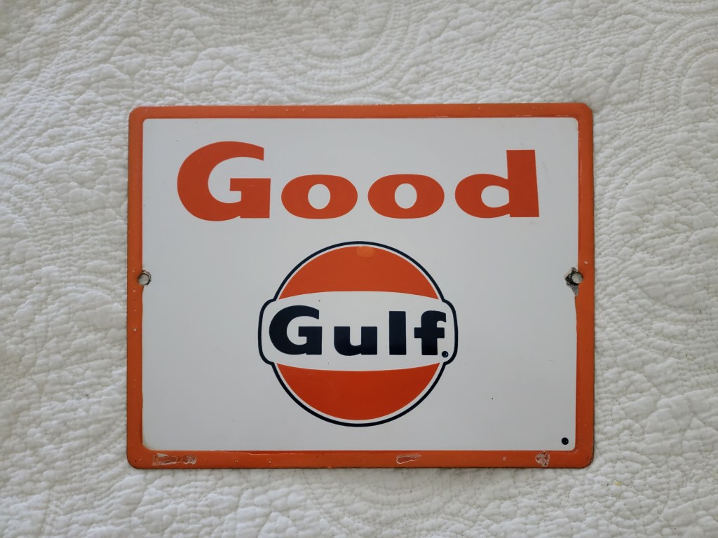 Vintage metal sign featuring the words 'Good Gulf' with an orange and white color scheme.