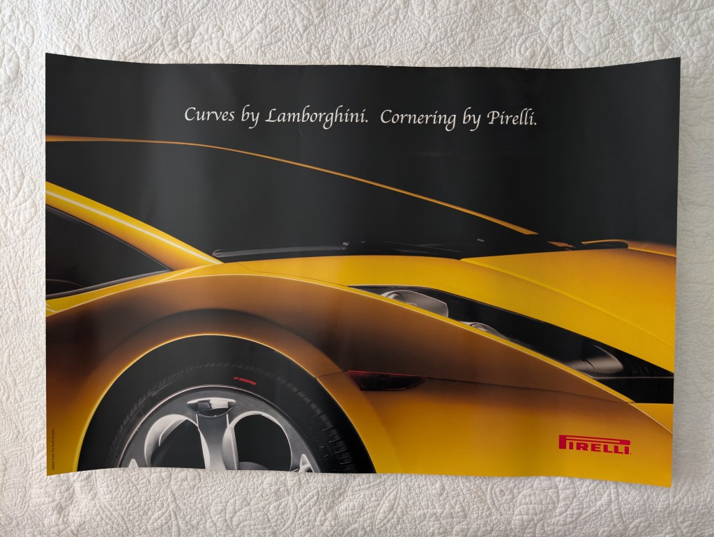 A promotional poster featuring a close-up view of a sleek yellow Lamborghini sports car, highlighting its curves and design elements. The text reads, 'Curves by Lamborghini. Cornering by Pirelli.' with the Pirelli logo visible.

pirelli poster
lamborghini huracn