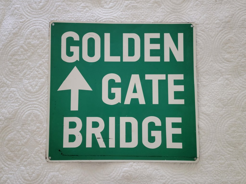 Sign indicating the direction to the Golden Gate Bridge with an upward arrow.
road sign
street sign collector