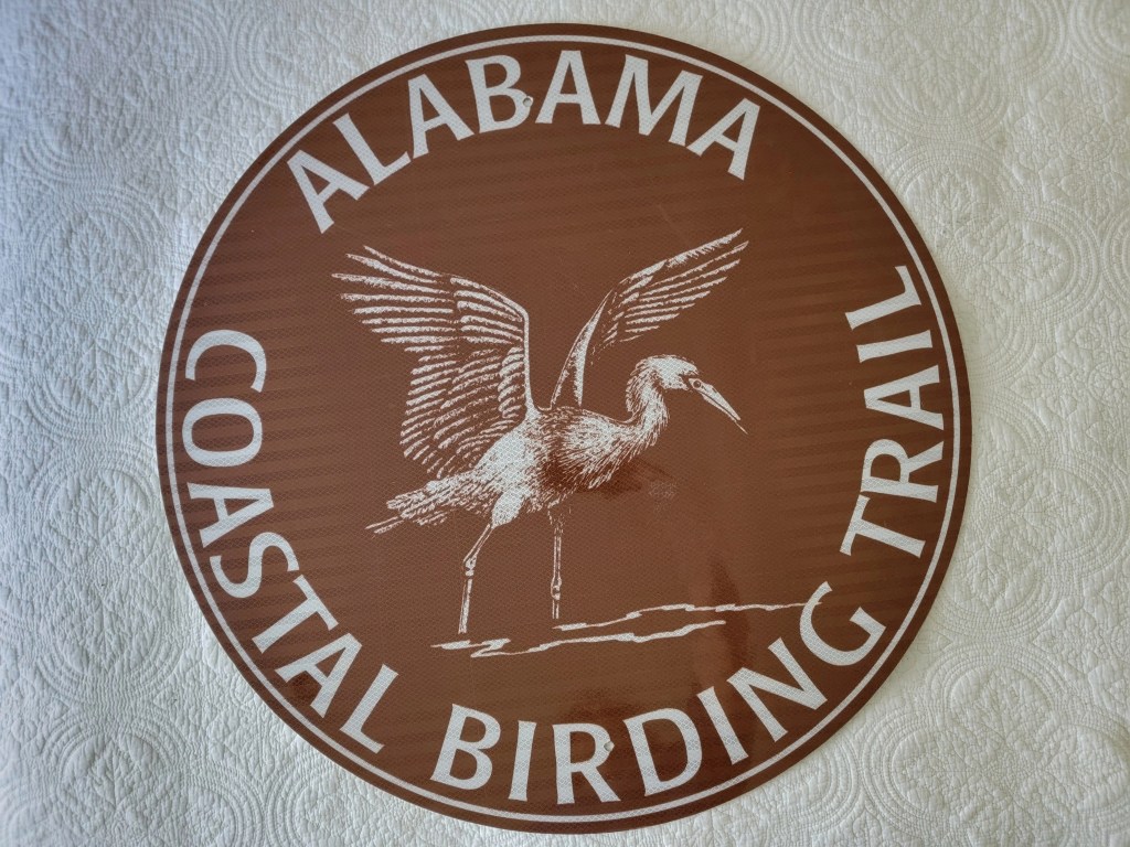 Sign for the Alabama Coastal Birding Trail featuring a bird illustration.
Heron