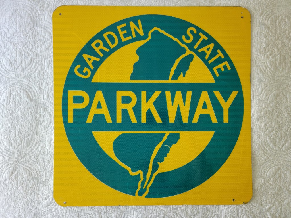 Sign for Garden State Parkway with green text and outline on a yellow background.
New Jersey Garden State Parkway Sign