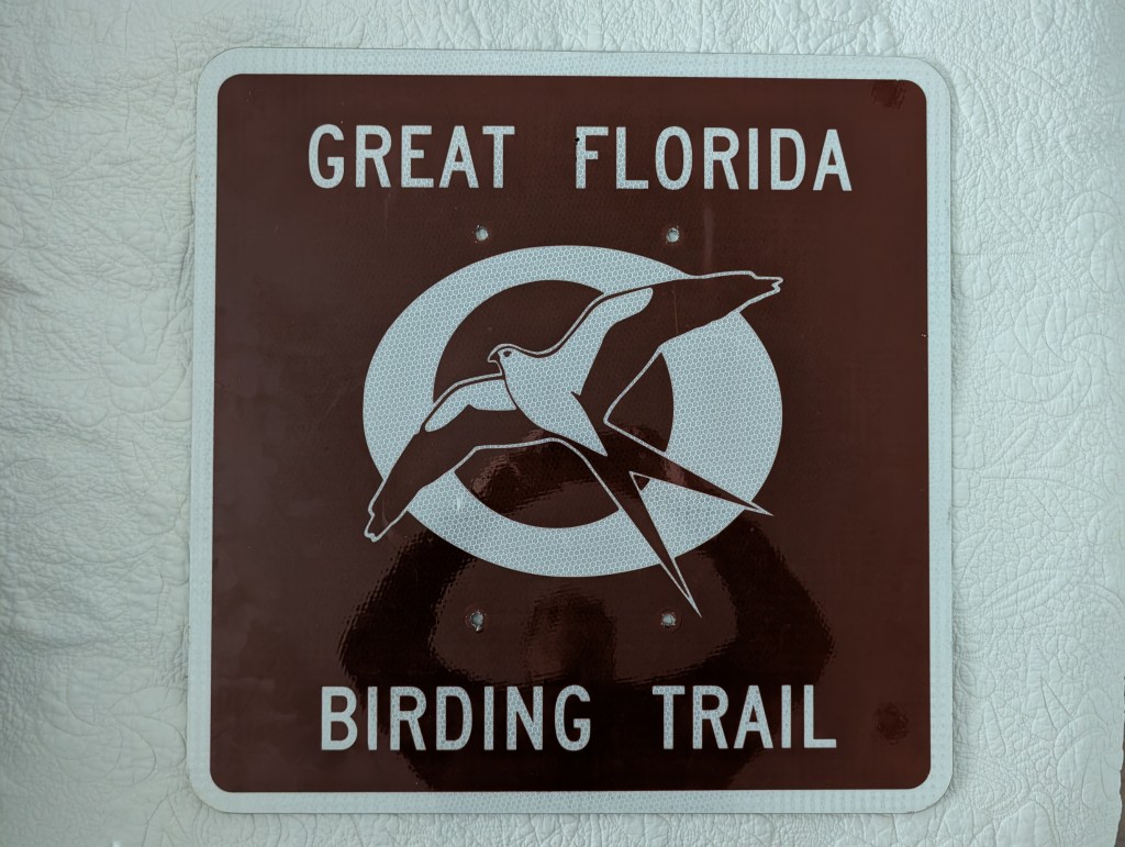 Sign for the Great Florida Birding Trail featuring a stylized bird illustration.
street sign